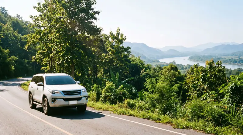 SUV on a hill road above the river valley west of Kanchanaburi